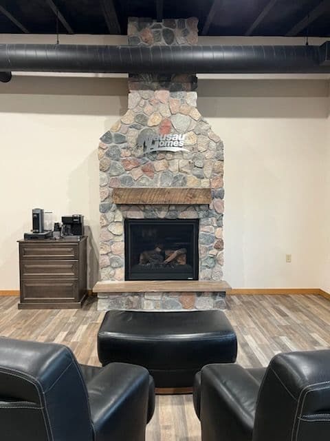 Stone fireplace with modern design in a cozy interior setting with leather seating.