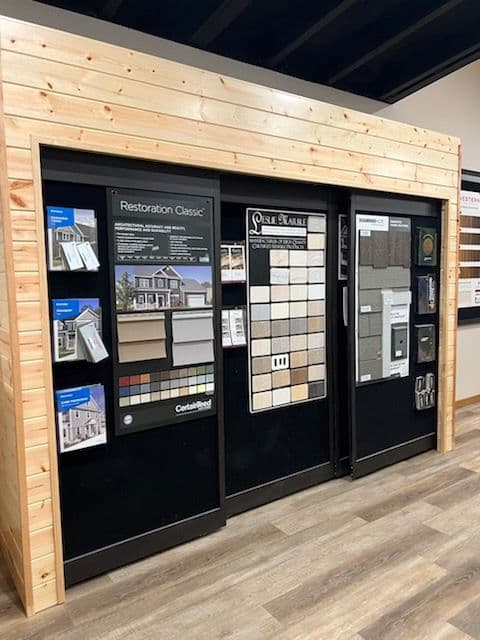 Display of exterior design samples including siding, paint, and flooring options.