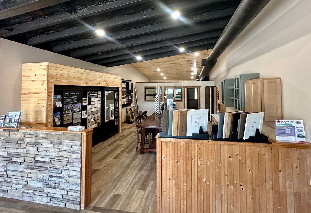 Modern interior of a design showroom featuring display boards and wooden accents.